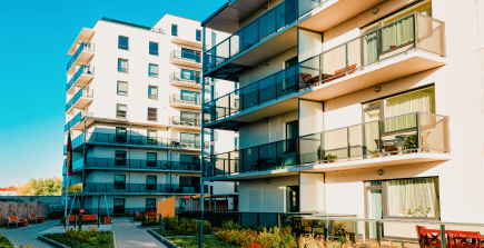 A modern condo building at sunset, symbolizing comprehensive condo insurance.